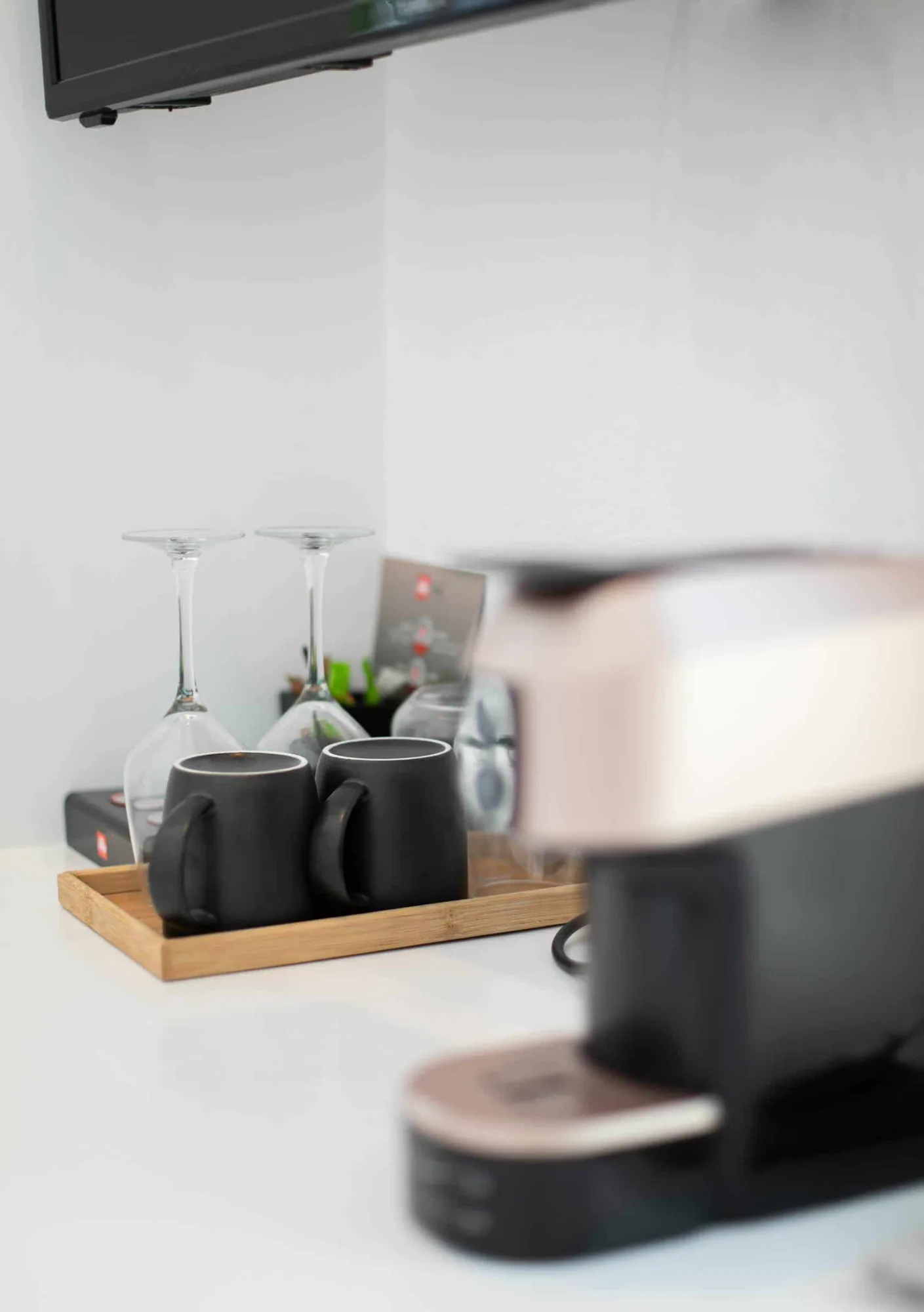 Espresso machine with cups on a wooden tray